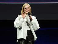 Elle Fanning speaks at Disney's presentation of Predator: Badlands at CinemaCon 2025 | Image via Getty